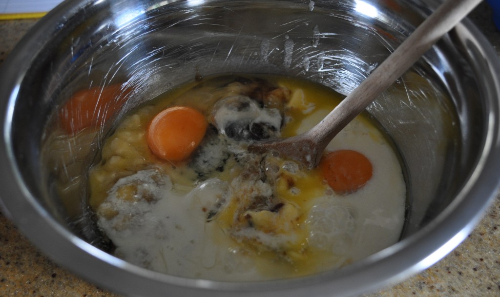 Mixing the wet ingredients for banana bread in a bowl