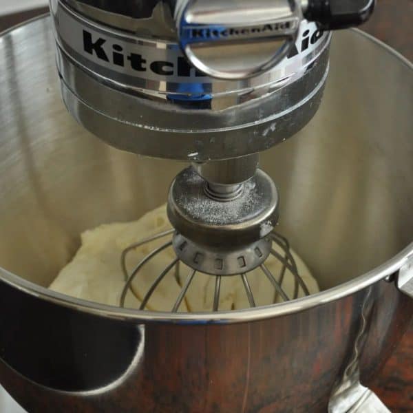 Step one of making homemade vanilla butter - cream and vanilla in a stand mixer
