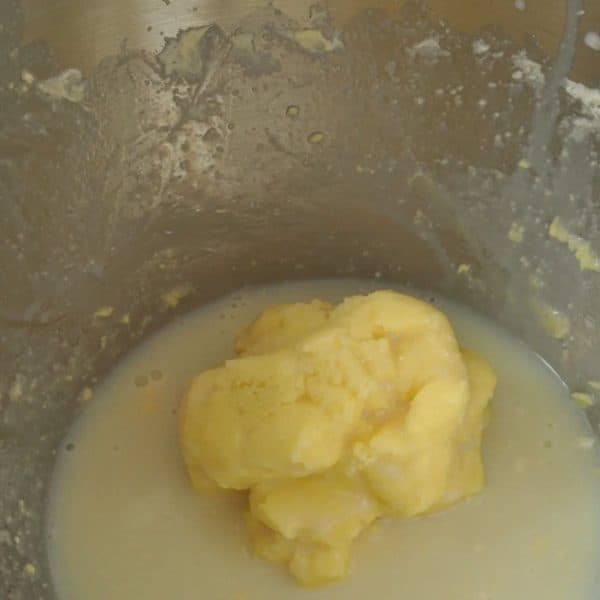 Homemade butter in a mixing bowl in buttermilk