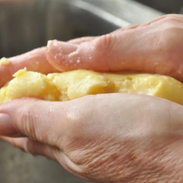 Homemade vanilla butter being pressed to release any excess buttermilk