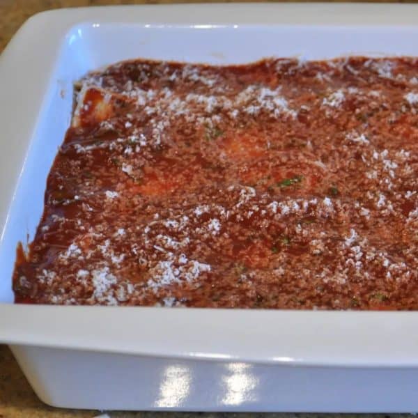 Adding more sauce on top of the lasagne sheets