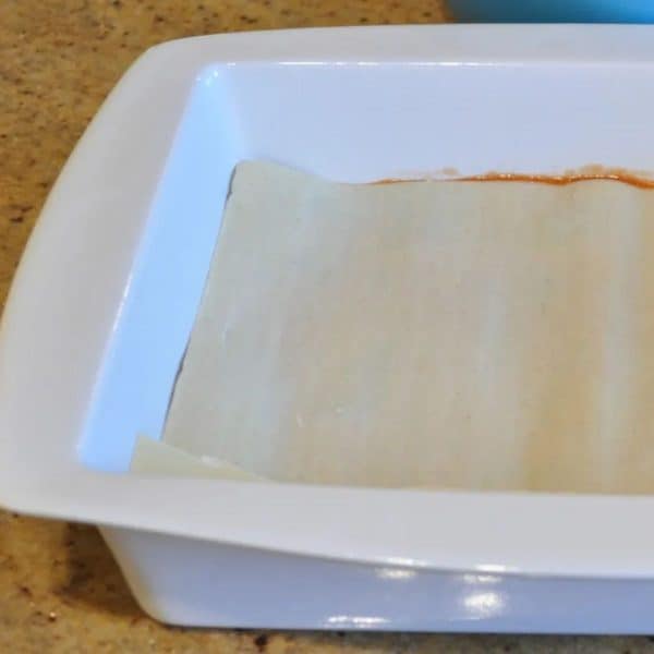 Adding the lasagne sheets to the baking dish