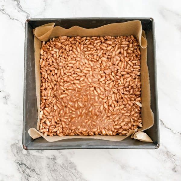 Mars bar slice spread into a tin