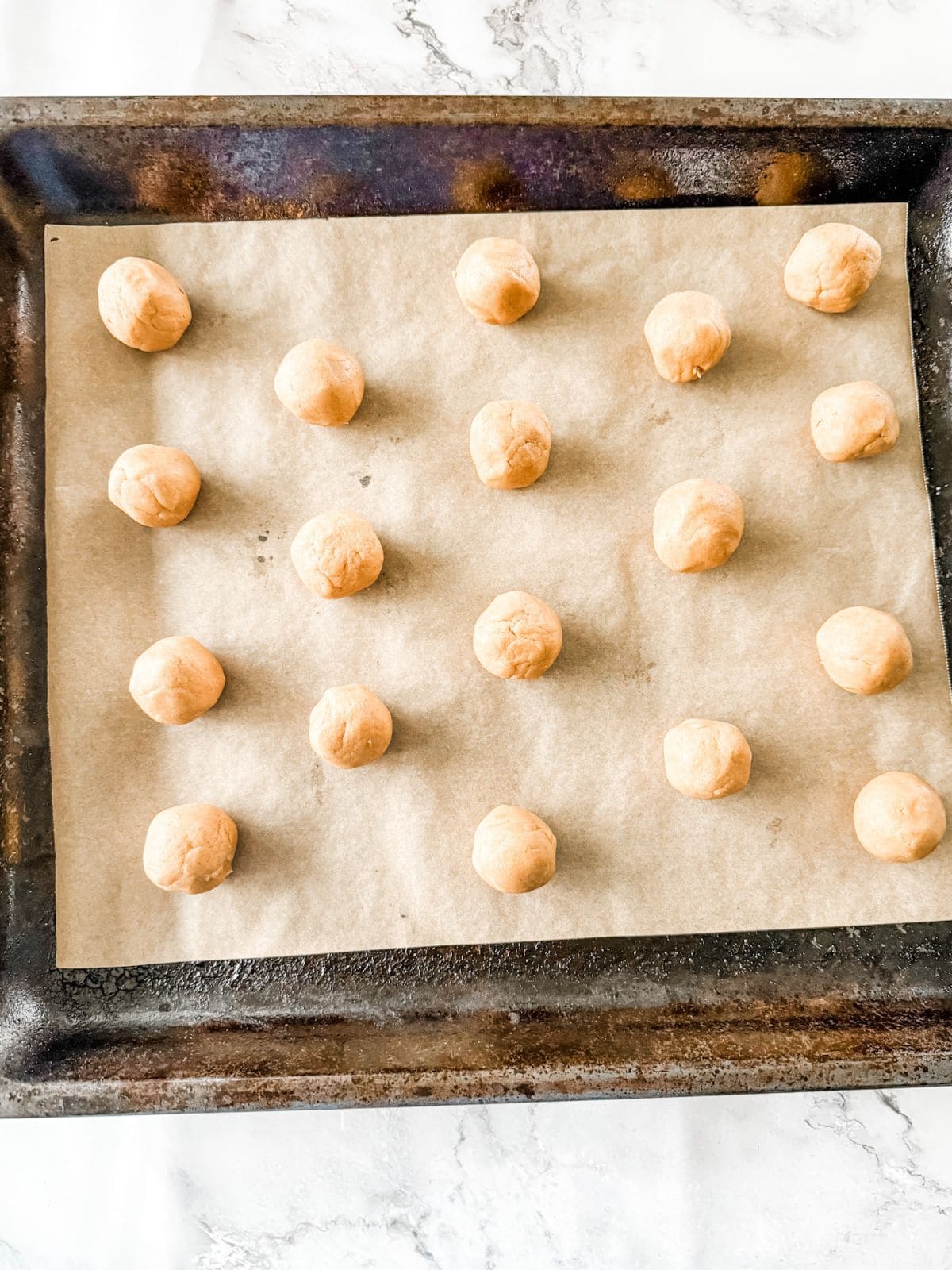 Gingernut biscuit dough balls on a tray ready