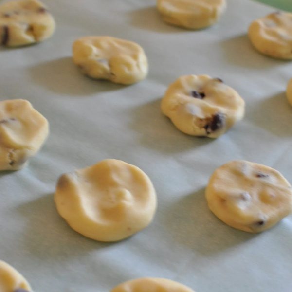 Flattening dough balls to make Sante biscuits