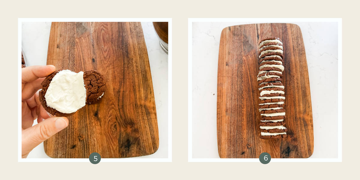 Sandwiching chocolate biscuits with cream to form a log on a wooden chopping board.