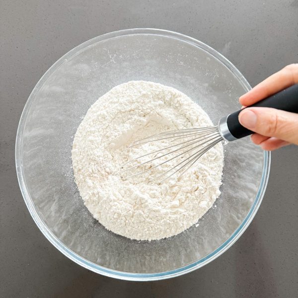 Whisking flour yeast and salt together to make ciabatta dough