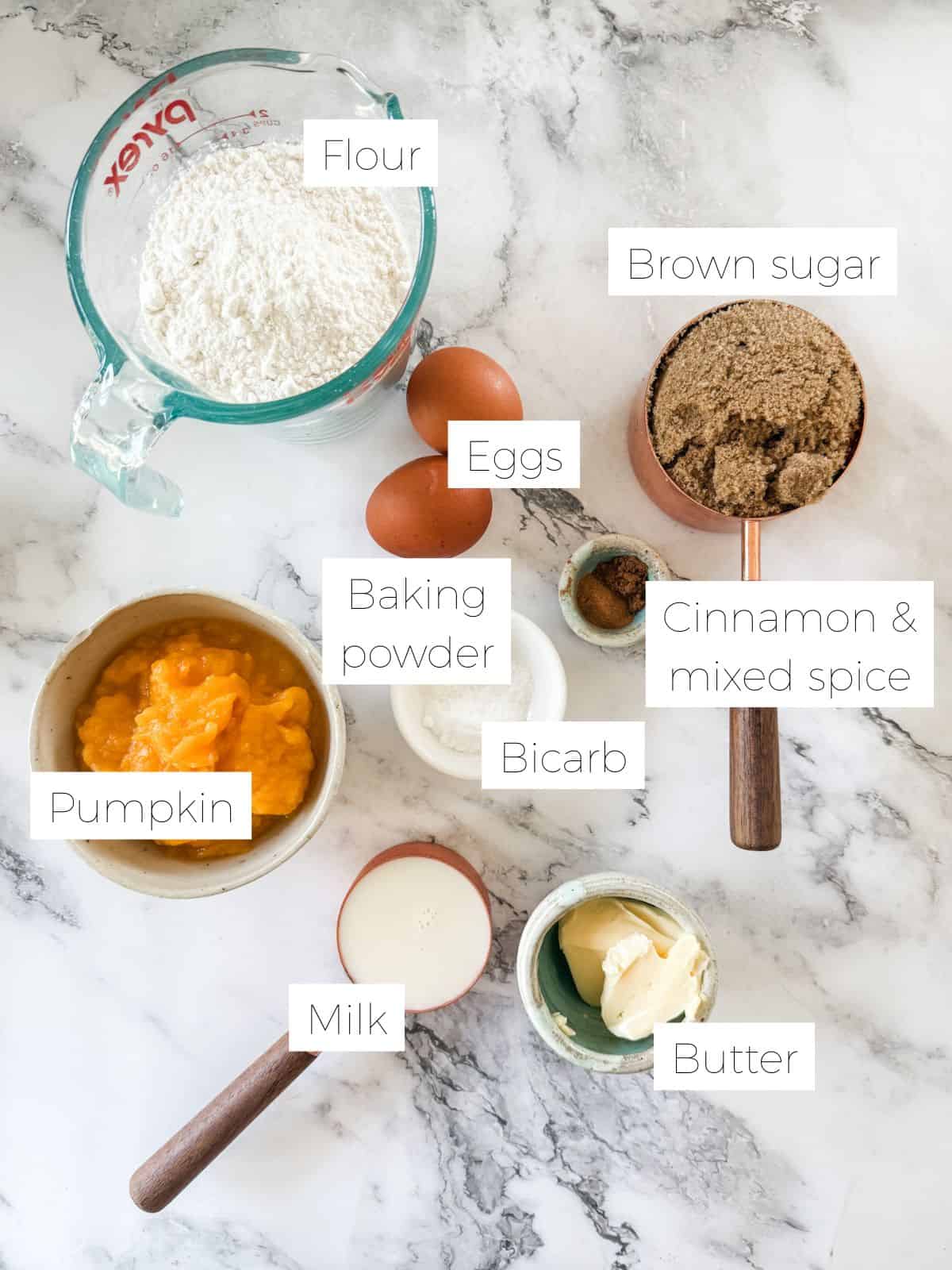 Ingredients in Pumpkin Bread With Cream Cheese Icing - bowls of flour, pumpkin, brown sugar, butter, 2 eggs.
