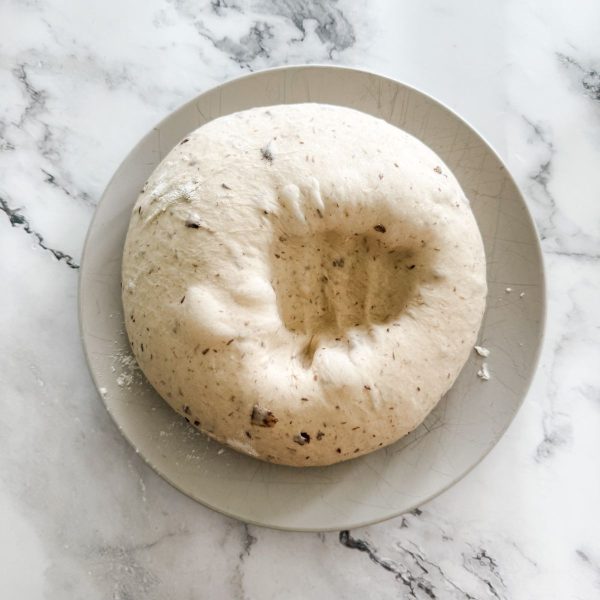 Hand print from being punched with a fist in olive bread dough. 