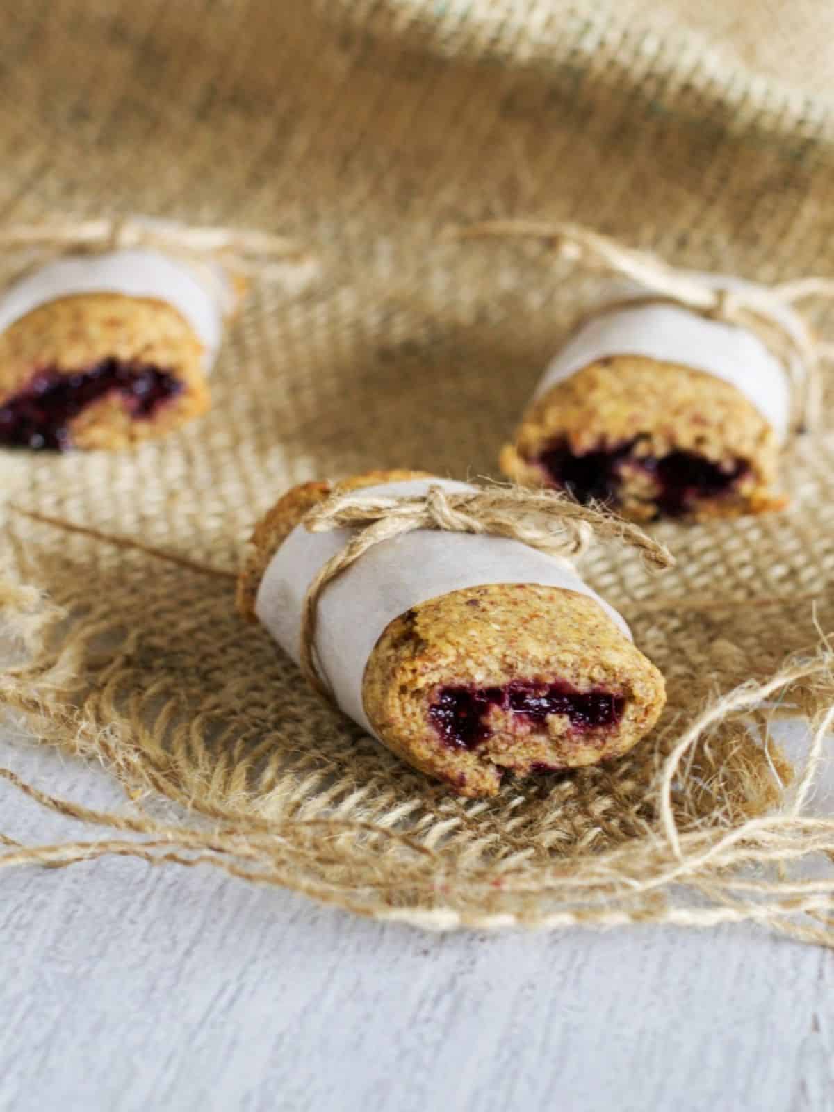3 Berry Breakfast Bars with baking paper wrap on hessian bag.