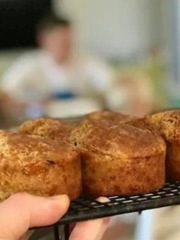 Cheese and corn muffins with ham on a cooling rack