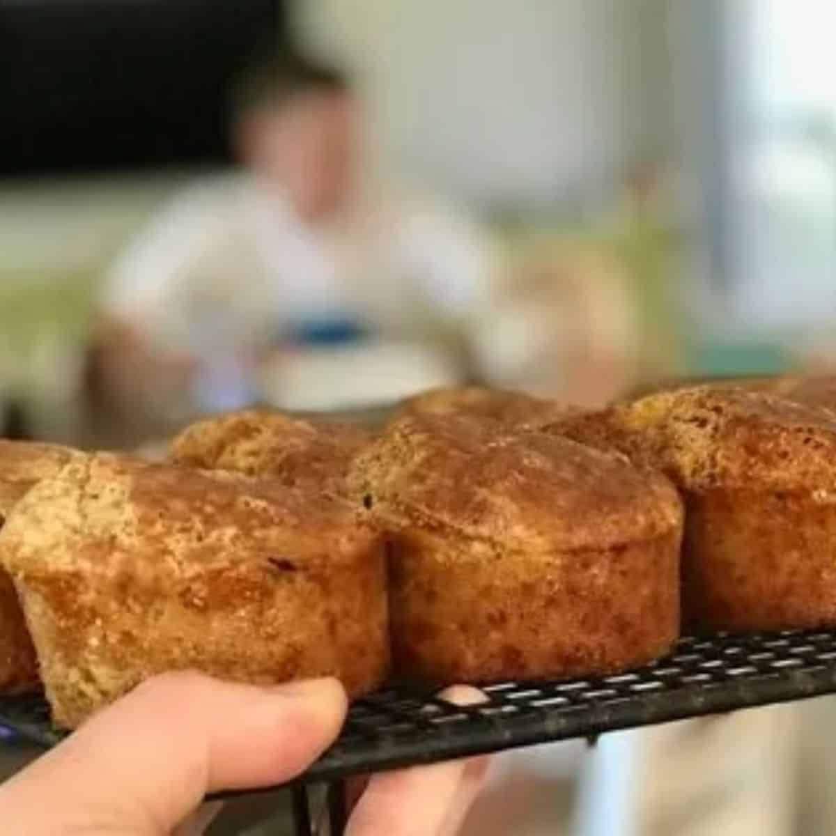 Cheese and corn muffins with ham on a cooling rack