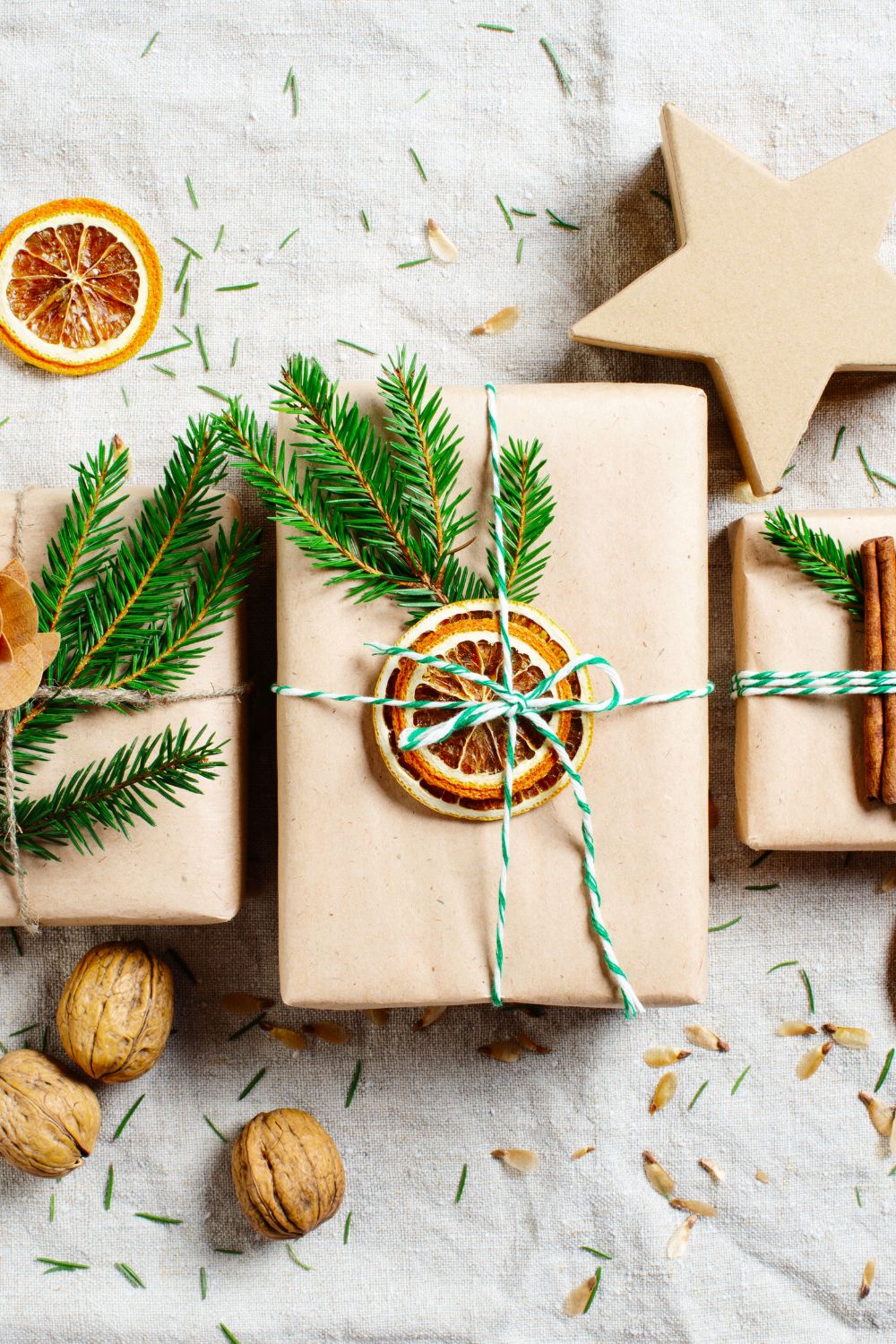 Dried citrus fruit decorating a Christmas gift wrapped in brown paper - elegant Christmas wrapping idea