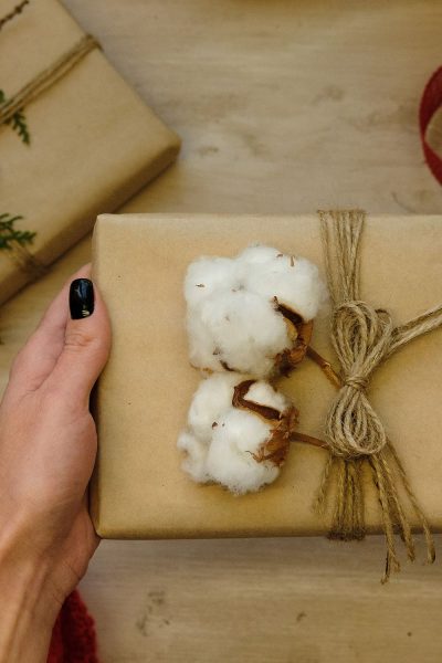 Cotton decorated Christmas present wrapped in brown paper