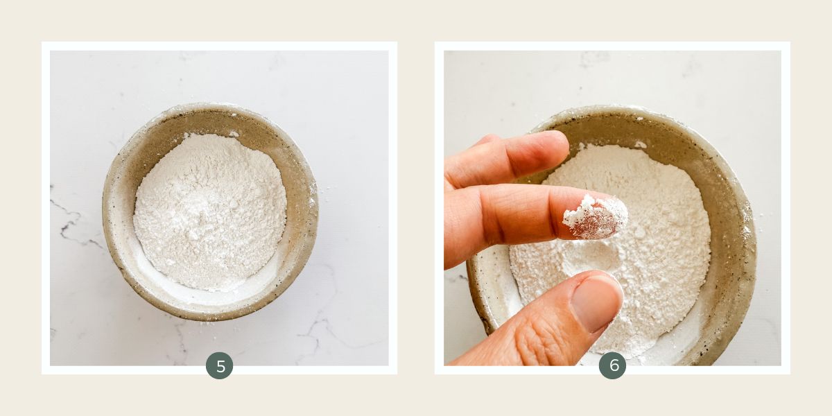 Homemade icing sugar in a bowl and being rubbed between fingers. 