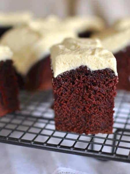 Best red velvet cake with buttercream icing (frosting) close up of a square slice