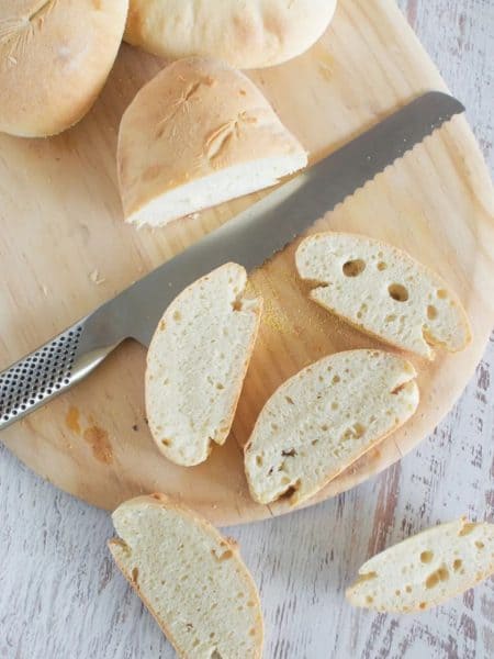 30 minute bread sliced on a chopping board with a silver bread knife