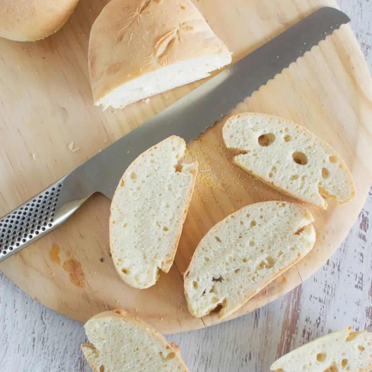 30 minute bread sliced on a chopping board with a silver bread knife