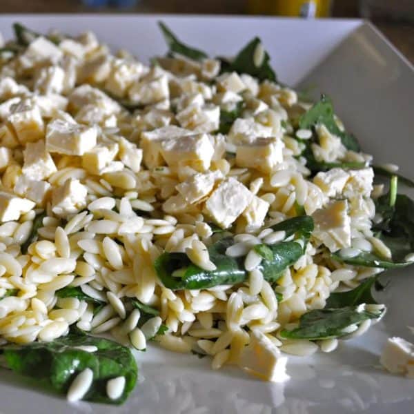 Serving the risoni salad and topping with feta