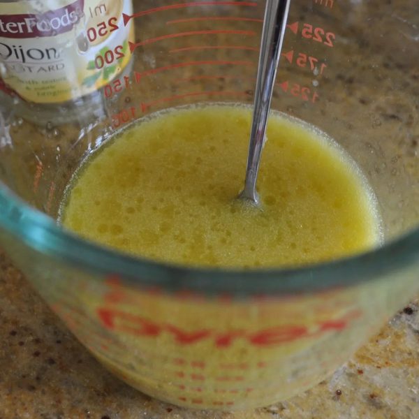 Whisking the dressing for lemon risoni salad