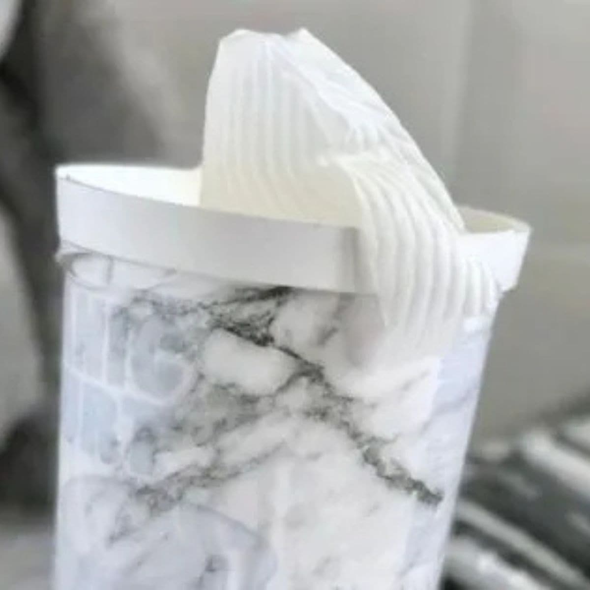 homemade baby wipes in a plastic marble pattern container