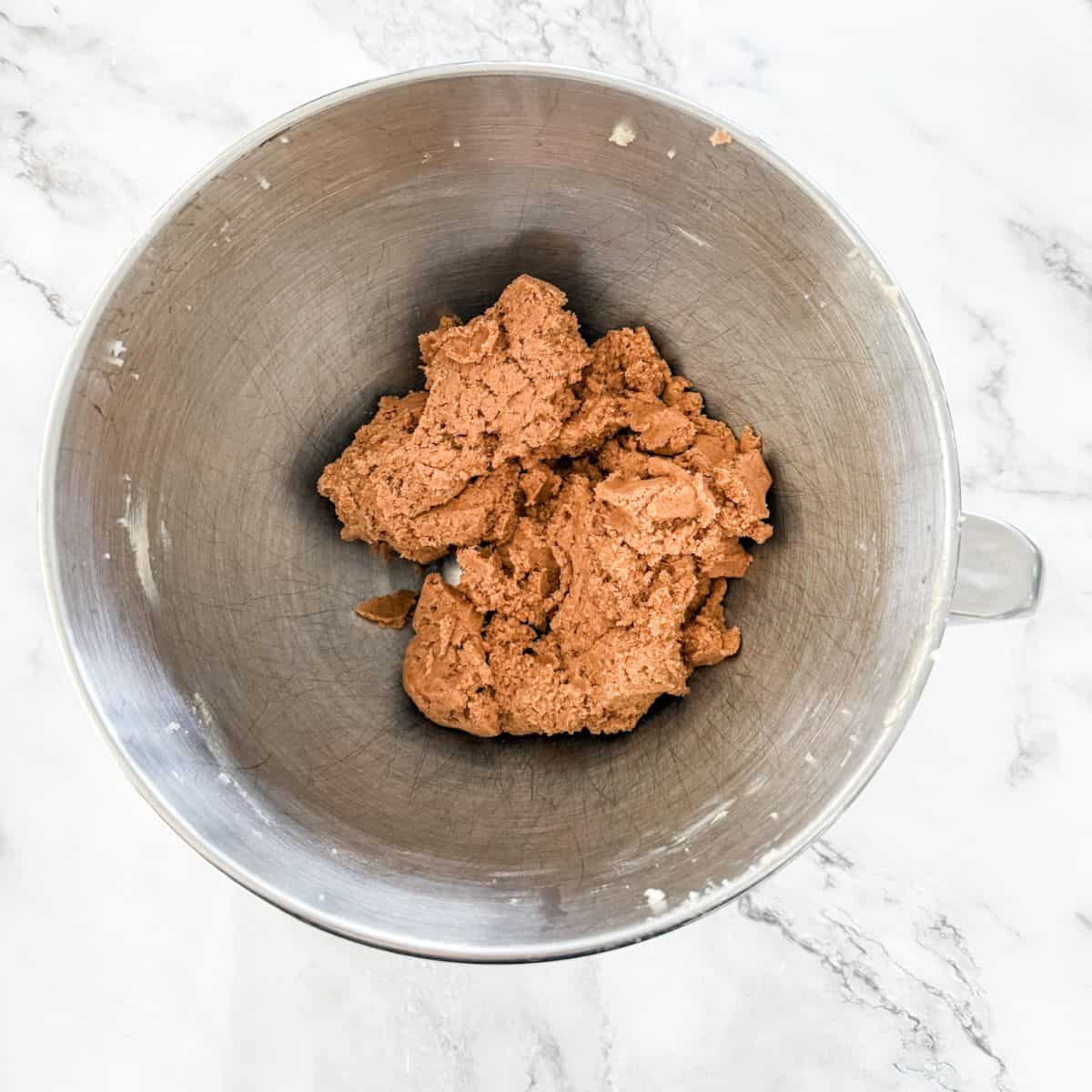Milo Biscuit dough in a silver mixing bowl. 