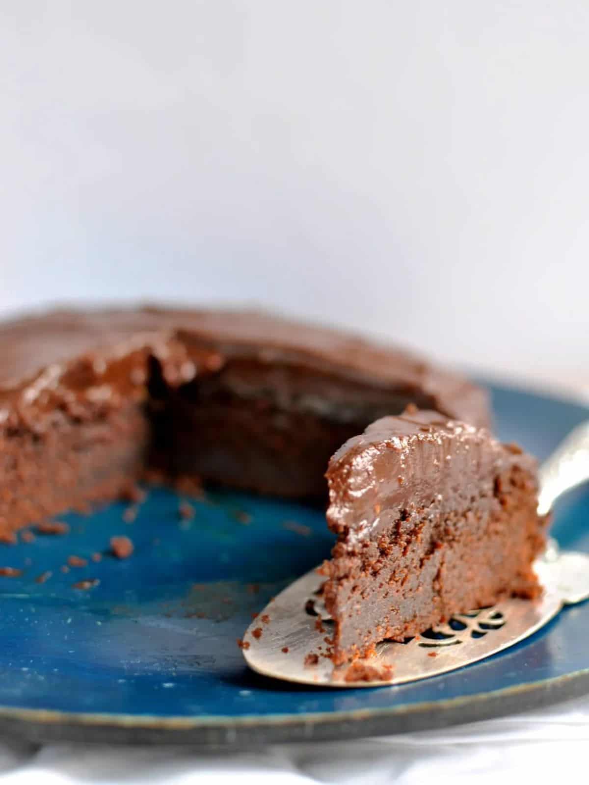 The best ever chocolate mud cake slice on silve cake server