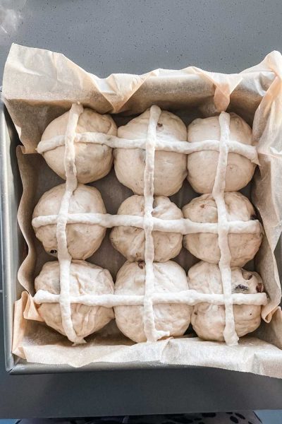 Best soft fluffy hot cross buns recipe (with sourdough) ready to go in the oven