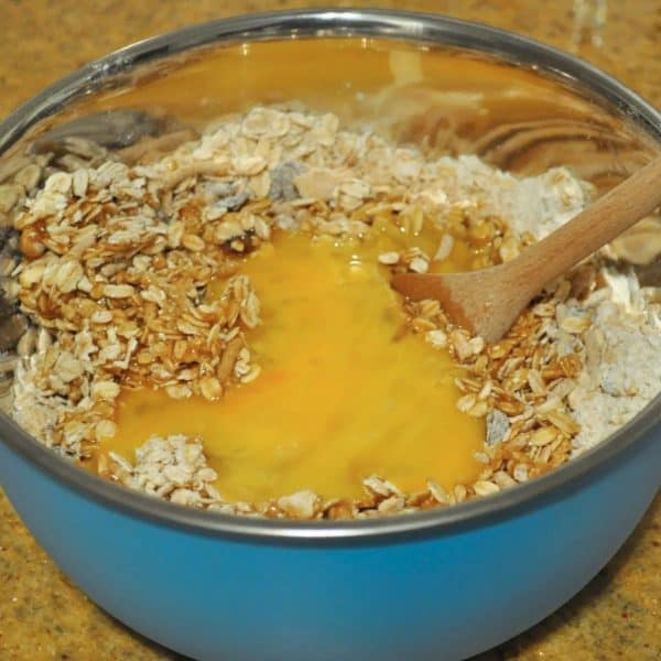 Adding the eggs to the batter for muesli bars
