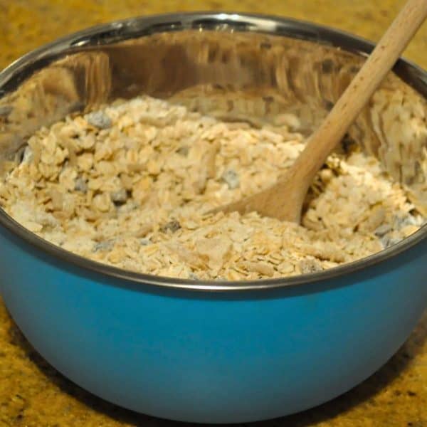 Mixing muesli and flour to make homemade muesli bars with packet muesli