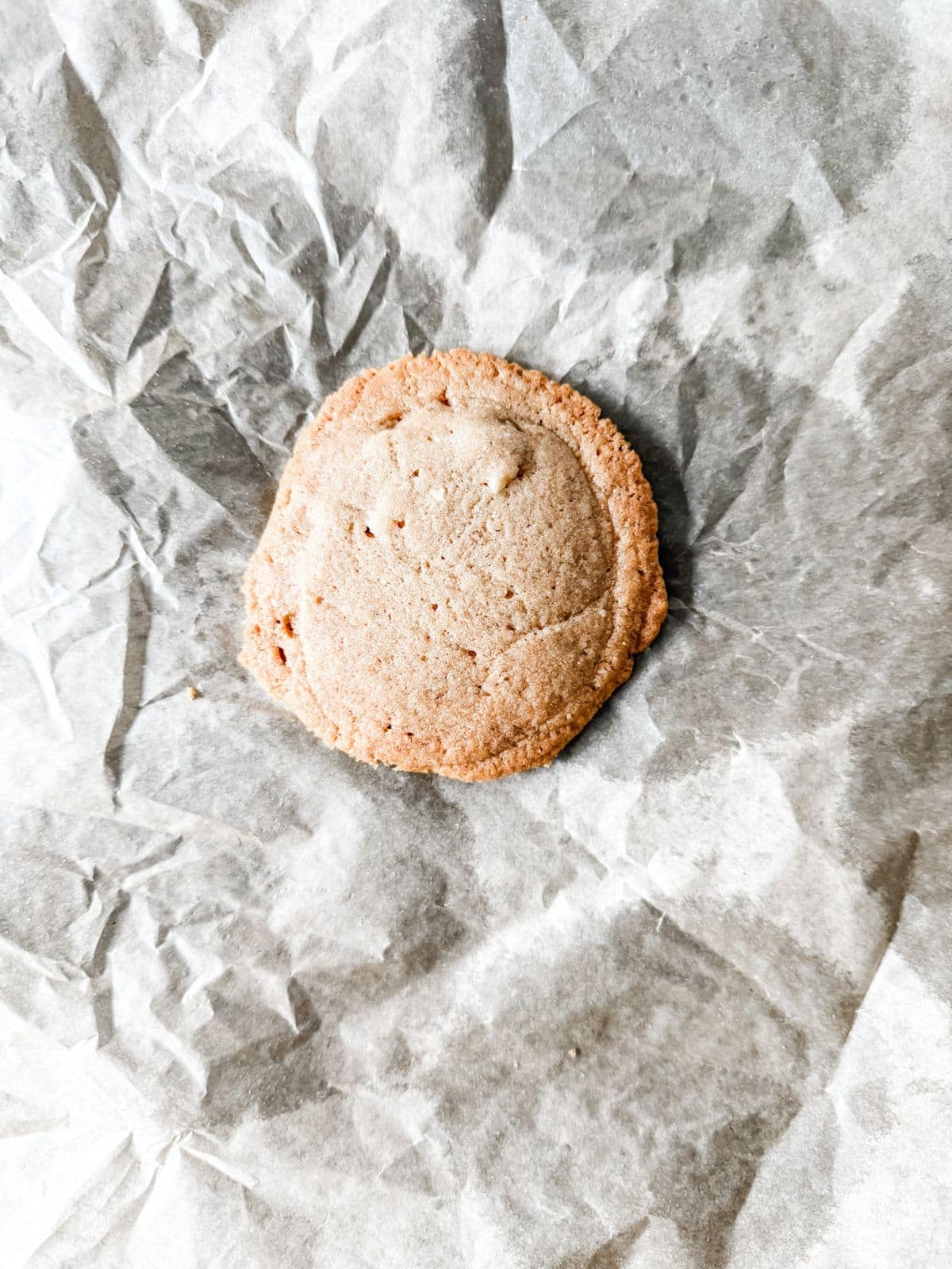Baked cookie on parchment paper.