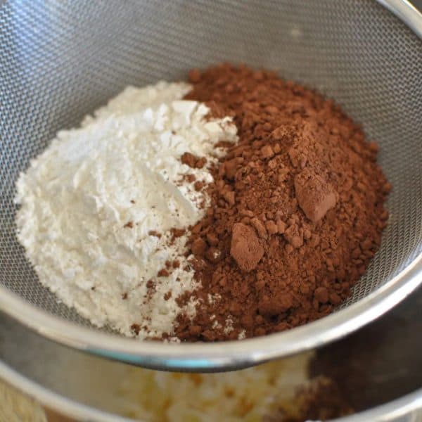Afghan biscuits - sifting flour and cocoa