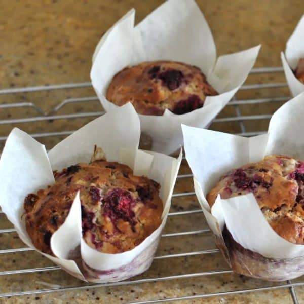 Healthy raspberry and white chocolate muffins cooling on a wire rack