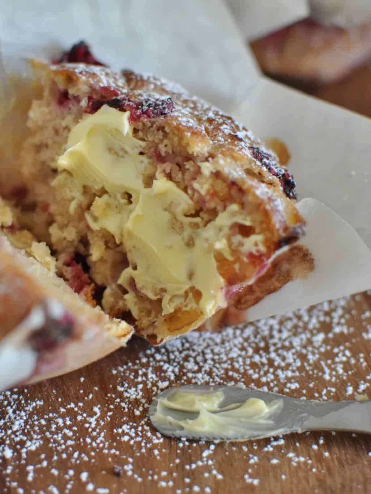 Healthy raspberry and white chocolate muffins cut with butter
