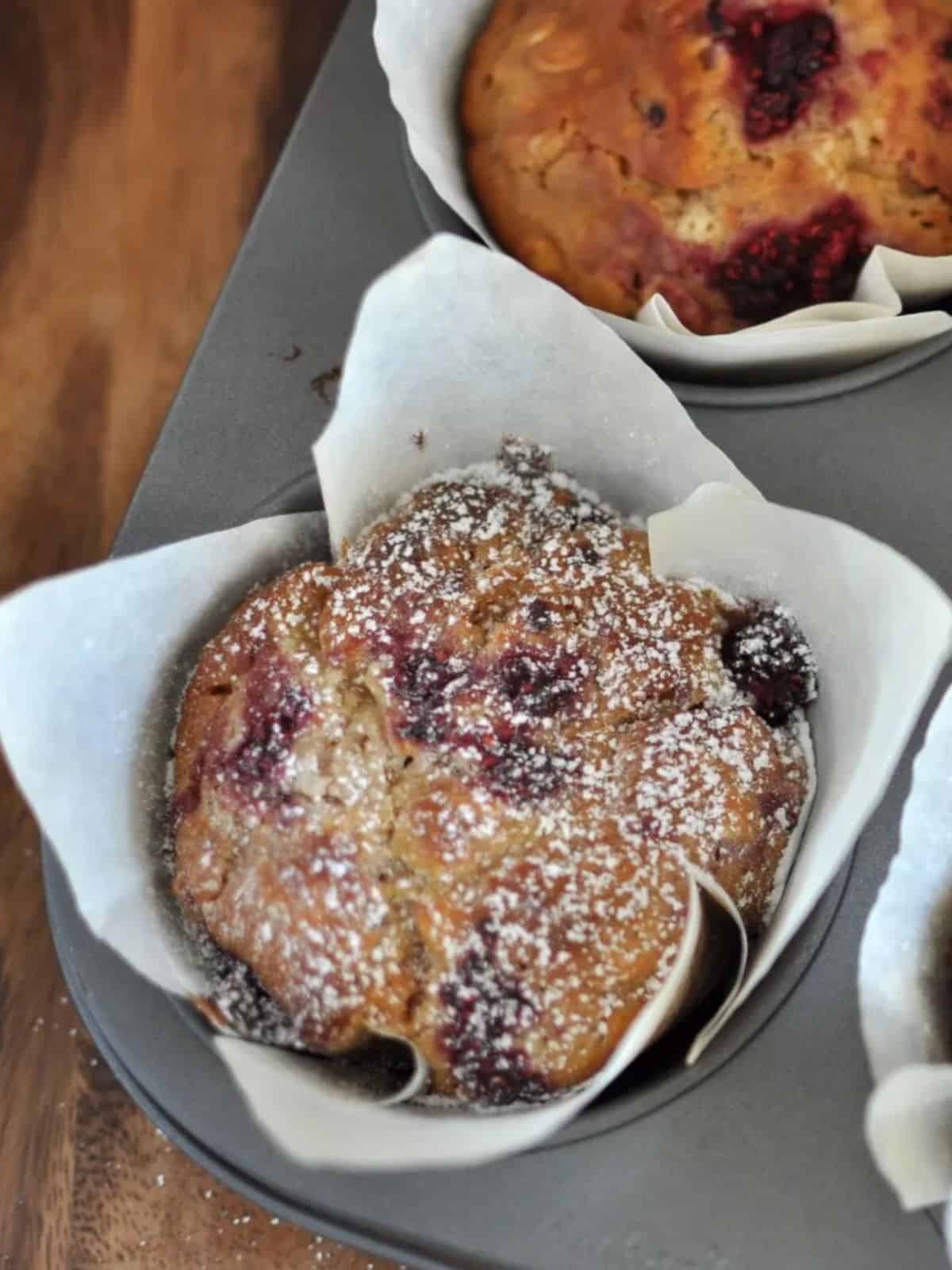 Healthy raspberry and white chocolate muffins in rustic wrapper