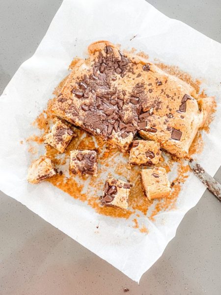 Gluten free blondies with chocolate chunks sliced on baking paper
