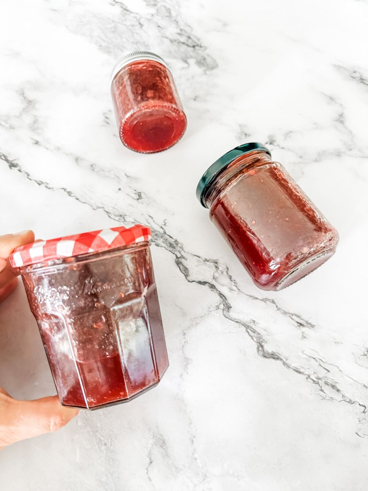 Strawberry jam made in the Thermomix - 3 jars on a marble bench top
