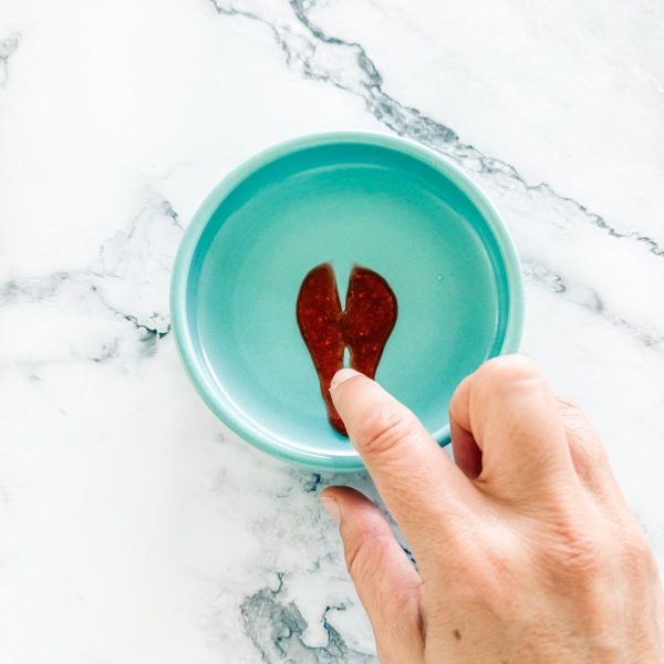 Testing strawberry jam - blob of jam on a plate with line through it