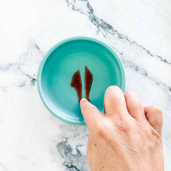 Testing strawberry jam - blob of jam on a plate with solid line through