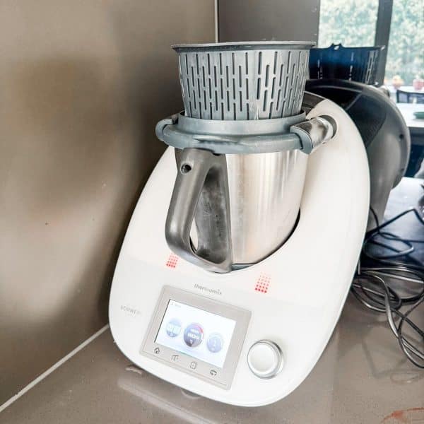 Thermomix making strawberry jam - A Thermomix with steamer basket on top