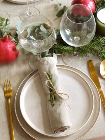 Christmas lunch setting with gold cutlery.